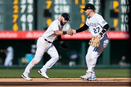 Apr 1, 2021; Denver, Colorado, USA; Colorado Rockies second baseman Chris Owings (12) celebrates with shortstop Trevor Story (27) after turning a double play in the seventh inning against the Los Angeles Dodgers at Coors Field. Mandatory Credit: Isaiah J. Downing-USA TODAY Sports
