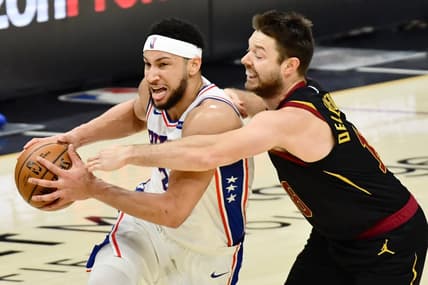 Apr 1, 2021; Cleveland, Ohio, USA; Cleveland Cavaliers guard Matthew Dellavedova (18) fouls Philadelphia 76ers guard Ben Simmons (25) during the third quarter at Rocket Mortgage FieldHouse. Mandatory Credit: Ken Blaze-USA TODAY Sports