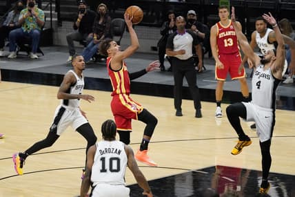 Apr 1, 2021; San Antonio, Texas, USA; Atlanta Hawks guard Trae Young (11) attempts the final shot of the fourth quarter for the win over San Antonio Spurs guard Derrick White (4) at AT&T Center. Mandatory Credit: Scott Wachter-USA TODAY Sports