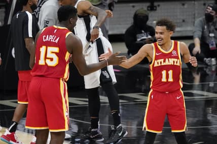 Apr 1, 2021; San Antonio, Texas, USA; Atlanta Hawks center Clint Capela (15) and guard Trae Young (11) celebrate after their double overtime victory over the San Antonio Spurs at AT&T Center. Mandatory Credit: Scott Wachter-USA TODAY Sports