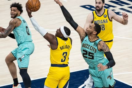 Apr 2, 2021; Indianapolis, Indiana, USA; Indiana Pacers guard Aaron Holiday (3) shoots the ball while Charlotte Hornets forward P.J. Washington (25) defends in the second quarter at Bankers Life Fieldhouse. Mandatory Credit: Trevor Ruszkowski-USA TODAY Sports