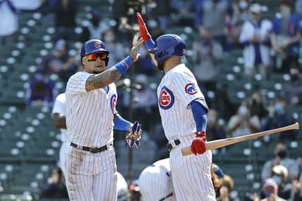Apr 3, 2021; Chicago, Illinois, USA; Chicago Cubs shortstop Javier Baez (9) celebrates with second baseman David Bote (13) after scoring against the Pittsburgh Pirates in the second inning at Wrigley Field. Mandatory Credit: Kamil Krzaczynski-USA TODAY Sports