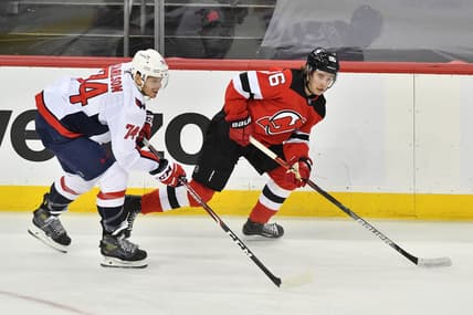Apr 4, 2021; Newark, New Jersey, USA; New Jersey Devils center Jack Houghes (86) skates with the puck against Washington Capitals defenseman John Carlson (74) during the first period at Prudential Center. Mandatory Credit: Catalina Fragoso-USA TODAY Sports
