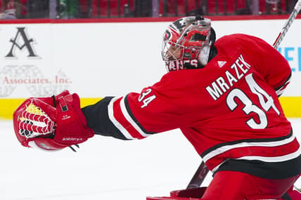 Apr 4, 2021; Raleigh, North Carolina, USA;  Carolina Hurricanes goaltender Petr Mrazek (34) makes a second period glove save against the Dallas Stars at PNC Arena. Mandatory Credit: James Guillory-USA TODAY Sports