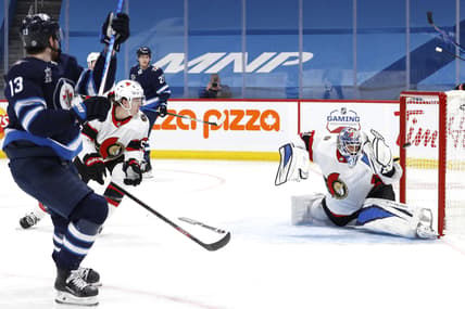 Apr 5, 2021; Winnipeg, Manitoba, CAN;  Winnipeg Jets left wing Pierre-Luc Dubois (13) scores on Ottawa Senators goaltender Anton Forsberg (31) in the second period at Bell MTS Place. Mandatory Credit: James Carey Lauder-USA TODAY Sports