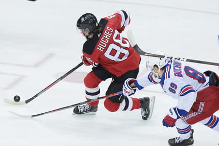 Apr 13, 2021; Newark, New Jersey, USA; New Jersey Devils center Jack Hughes (86) skates with the puck against New York Rangers right wing Pavel Buchnevich (89) during the first period at Prudential Center. Mandatory Credit: Vincent Carchietta-USA TODAY Sports
