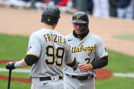 Apr 25, 2021; Minneapolis, Minnesota, USA; Pittsburgh Pirates left fielder Phillip Evans (24) celebrates with designated hitter Todd Frazier (99) after scoring a run against the Minnesota Twins in the first inning at Target Field. Mandatory Credit: David Berding-USA TODAY Sports