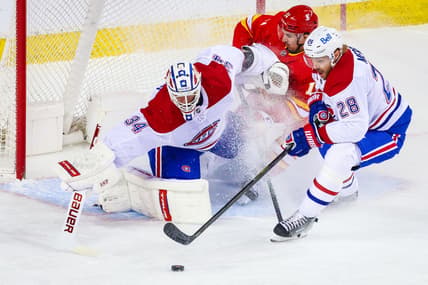 Apr 26, 2021; Calgary, Alberta, CAN; Montreal Canadiens goaltender Jake Allen (34) makes a save against Calgary Flames center Mikael Backlund (11) during the first period at Scotiabank Saddledome. Mandatory Credit: Sergei Belski-USA TODAY Sports