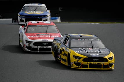 Oct 11, 2020; Concord, North Carolina, USA; NASCAR Cup Series driver Brad Keselowski (2) races ahead of Matt DiBenedetto (21) and Chase Elliott (9)during the Bank of America ROVAL 400 at Charlotte Motor Speedway. Mandatory Credit: Jasen Vinlove-USA TODAY Sports