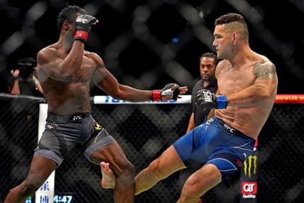 Apr 24, 2021; Jacksonville, Florida, USA; Chris Weidman (Blue Gloves) breaks his leg on his first kick against Uriah Hall (Red Gloves) during UFC 261 at VyStar Veterans Memorial Arena. Mandatory Credit: Jasen Vinlove-USA TODAY Sports