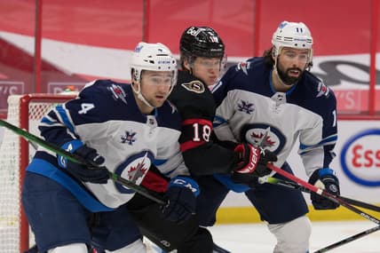 May 3, 2021; Ottawa, Ontario, CAN; Winnipeg Jets defenseman Neal Pionk (4) and center Nate Thompson (11) defend against Ottawa Senators left wing Tim St tzle (18) in the second period at the Canadian Tire Centre. Mandatory Credit: Marc DesRosiers-USA TODAY Sports