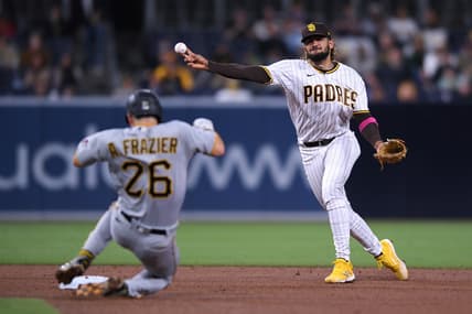 May 3, 2021; San Diego, California, USA; San Diego Padres shortstop Fernando Tatis Jr. (R) throws to first base on a ground out by Pittsburgh Pirates center fielder Bryan Reynolds (not pictured) as second baseman Adam Frazier (26) slides into second base during the fifth inning at Petco Park. Mandatory Credit: Orlando Ramirez-USA TODAY Sports