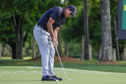 May 6, 2021; Charlotte, North Carolina, USA;  Phil Mickelson putts for his two stroke lead at 9 during the first round of the Wells Fargo Championship golf tournament. Mandatory Credit: Jim Dedmon-USA TODAY Sports
