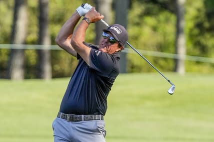 May 6, 2021; Charlotte, North Carolina, USA; Phil Mickelson hits his approach shot to the 9th green during the first round of the Wells Fargo Championship golf tournament. Mandatory Credit: Jim Dedmon-USA TODAY Sports