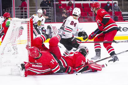 May 6, 2021; Raleigh, North Carolina, USA;  Carolina Hurricanes defenseman Jaccob Slavin (74) collides with goaltender Petr Mrazek (34) during the first period at PNC Arena. Mandatory Credit: James Guillory-USA TODAY Sports