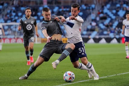 May 12, 2021; Saint Paul, MN, USA; Minnesota United midfielder Jan Gregus (8) defends Vancouver Whitecaps forward Russell Teibert (31) in the first half at Allianz Field. Mandatory Credit: Brad Rempel-USA TODAY Sports