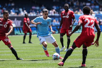 May 15, 2021; New York, New York, USA; New York City FC forward Jesus Medina (19) controls the ball against Toronto FC midfielder Richie Laryea (22) during the first half at Yankee Stadium. Mandatory Credit: Vincent Carchietta-USA TODAY Sports