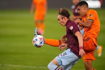 May 15, 2021; Commerce City, Colorado, USA; Houston Dynamo defender Jose Bizama (16) and Colorado Rapids defender Sam Vines (13) battle for the ball during the first half at Dick's Sporting Goods Park. Mandatory Credit: Ron Chenoy-USA TODAY Sports