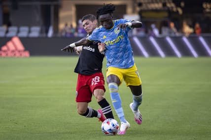 May 23, 2021; Washington, DC, Washington, DC, USA; D.C. United defender Joseph Mora (28) and Philadelphia Union defender Olivier Mbaizo (15) battle for the ball during the first half at Audi Field. Mandatory Credit: Scott Taetsch-USA TODAY Sports