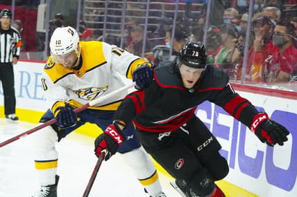 May 25, 2021; Raleigh, North Carolina, USA; Carolina Hurricanes left wing Steven Lorentz (78) and Nashville Predators center Colton Sissons (10) battle during the third period in game five of the first round of the 2021 Stanley Cup Playoffs at PNC Arena. Mandatory Credit: James Guillory-USA TODAY Sports