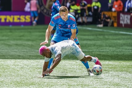 May 29, 2021; Atlanta, Georgia, USA; Atlanta United forward Josef Martinez (7) is knocked down by Nashville SC defender Dave Romney (4) during the first half at Mercedes-Benz Stadium. Mandatory Credit: Dale Zanine-USA TODAY Sports