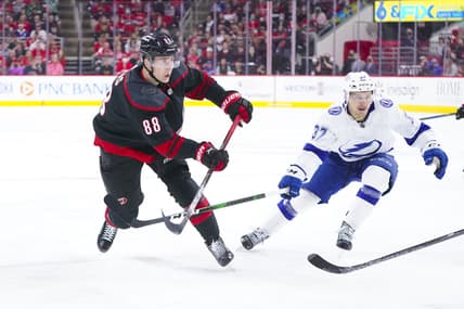 May 30, 2021; Raleigh, North Carolina, USA; Carolina Hurricanes center Martin Necas (88) takes a shot against Tampa Bay Lightning center Yanni Gourde (37) in game one of the second round of the 2021 Stanley Cup Playoffs at PNC Arena. Mandatory Credit: James Guillory-USA TODAY Sports