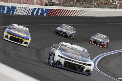 May 30, 2021; Concord, North Carolina, USA; NASCAR Cup Series driver Kyle Larson (5) fends off driver Chase Elliott (9) during the Coca-Cola 600 at Charlotte Motor Speedway. Mandatory Credit: Jim Dedmon-USA TODAY Sports
