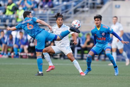 May 30, 2021; Seattle, Washington, USA; Seattle Sounders midfielder Joao Paulo (6) kicks the ball as Austin FC forward Cecilio Dominguez (10) watches during the first half at Lumen Field Field. Mandatory Credit: Jennifer Buchanan-USA TODAY Sports