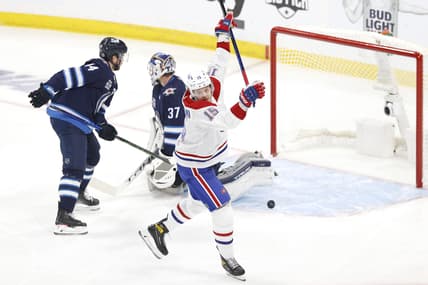 Jun 2, 2021; Winnipeg, Manitoba, CAN; Montreal Canadiens center Jesperi Kotkaniemi (15) scores a first period goal against Winnipeg Jets goaltender Connor Hellebuyck (37) in game one of the second round of the 2021 Stanley Cup Playoffs at Bell MTS Place. Mandatory Credit: James Carey Lauder-USA TODAY Sports
