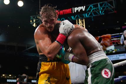 Jun 6, 2021; Miami, Florida, USA; Floyd Mayweather Jr. (Green Trunks) fights Logan Paul (Yellow Trunks) during an exhibition boxing match at Hard Rock Stadium. Mandatory Credit: Jasen Vinlove-USA TODAY Sports