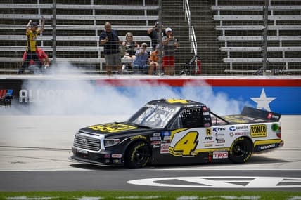 Jun 12, 2021; Fort Worth, TX, USA; NASCAR Camping World Truck Series driver John Hunter Nemechek (4) performs a burnout after he wins the SpeedyCash.com 220 race at the Texas Motor Speedway. Mandatory Credit: Jerome Miron-USA TODAY Sports