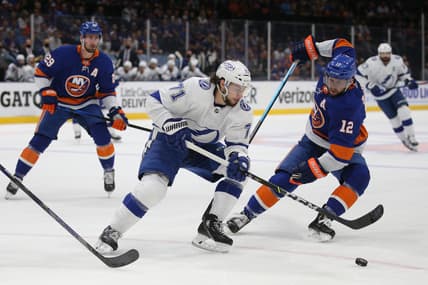 Jun 17, 2021; Uniondale, New York, USA; Tampa Bay Lightning center Anthony Cirelli (71) and New York Islanders center Josh Bailey (12) fight for the puck during the first period of game three of the 2021 Stanley Cup Semifinals at Nassau Veterans Memorial Coliseum. Mandatory Credit: Brad Penner-USA TODAY Sports
