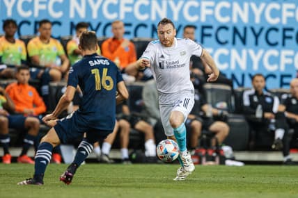 Jun 19, 2021; Harrison, New Jersey, USA; New England Revolution midfielder Thomas McNamara (26) controls the ball against New York City FC midfielder James Sands (16) during the first half at Red Bull Arena. Mandatory Credit: Vincent Carchietta-USA TODAY Sports