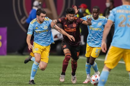 Jun 20, 2021; Atlanta, Georgia, USA; Atlanta United midfielder Marcelino Moreno (10) fights for the ball between Philadelphia Union defender Jack Elliott (3) and midfielder Jamiro Monteiro (10) during the first half at Mercedes-Benz Stadium. Mandatory Credit: Dale Zanine-USA TODAY Sports