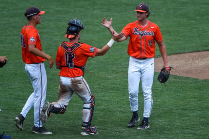 Jun 20, 2021; Omaha, Nebraska, USA; Virginia Cavaliers pitcher Matt Wyatt (15) celebrates the win with catcher Logan Michaels (12) against the Tennessee Volunteers at TD Ameritrade Park. Mandatory Credit: Steven Branscombe-USA TODAY Sports