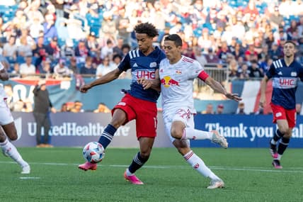 Jun 23, 2021; Foxborough, Massachusetts, USA; New York Red Bulls midfielder Sean Davis (27) defends New England Revolution midfielder Tajon Buchanan (17) during the first half at Gillette Stadium. Mandatory Credit: Paul Rutherford-USA TODAY Sports