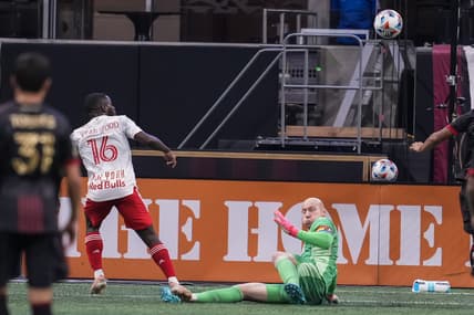 Jun 27, 2021; Atlanta, Georgia, USA; Atlanta United goalkeeper Brad Guzan (1) blocks a shot against New York Red Bulls midfielder Dru Yearwood (16) during the first half at Mercedes-Benz Stadium. Mandatory Credit: Dale Zanine-USA TODAY Sports