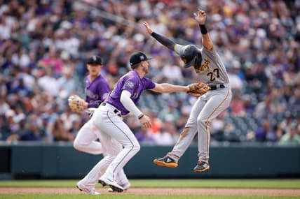 Jun 28, 2021; Denver, Colorado, USA; Pittsburgh Pirates second baseman Kevin Newman (27) avoids the tag from Colorado Rockies second baseman Ryan McMahon (24) as he runs to third in the fifth inning at Coors Field. Mandatory Credit: Isaiah J. Downing-USA TODAY Sports