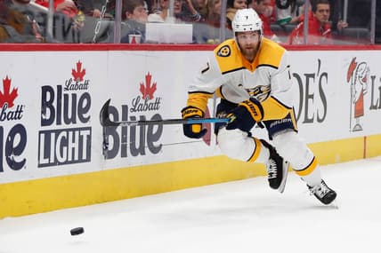 Nov 4, 2019; Detroit, MI, USA; Nashville Predators defenseman Yannick Weber (7) goes after the puck in the first period against the Detroit Red Wings at Little Caesars Arena. Mandatory Credit: Rick Osentoski-USA TODAY Sports