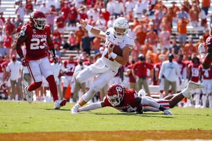Oct 10, 2020; Dallas, Texas, USA; Texas Longhorns quarterback Sam Ehlinger (11) runs past a tackle attempt by Oklahoma Sooners defensive back Brendan Radley-Hiles (44) during the second quarter of the Red River Showdown at Cotton Bowl. Mandatory Credit: Andrew Dieb-USA TODAY Sports