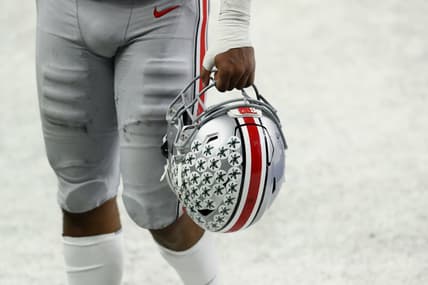 Dec 19, 2020; Indianapolis, Indiana, USA; A member of the Ohio State Buckeyes carries his helmet off the field after defeating the Northwestern Wildcats at Lucas Oil Stadium. Mandatory Credit: Aaron Doster-USA TODAY Sports