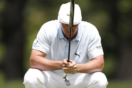 Jul 2, 2021; Detroit, Michigan, USA; Bryson DeChambeau lines up his putt on the 9th hole during the second round of the Rocket Mortgage Classic golf tournament. Mandatory Credit: Raj Mehta-USA TODAY Sports