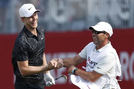 Jul 4, 2021; Detroit, Michigan, USA; Cam Davis celebrates with his caddie after making an eagle from a greenside bunker on the 17th hole during the final round of the Rocket Mortgage Classic golf tournament. Mandatory Credit: Raj Mehta-USA TODAY Sports