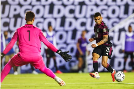 Jul 14, 2021; Dallas, Texas, USA; Mexico midfielder Orbel    n Pineda (10) assists a goal by Mexico forward Rogelio Funes Mori (not pictured) against Guatemala goalkeeper Nicholas Hagen (1) during the second half of CONCACAF Gold Cup Soccer group stage play at Cotton Bowl. Mandatory Credit: Ben Ludeman-USA TODAY Sports