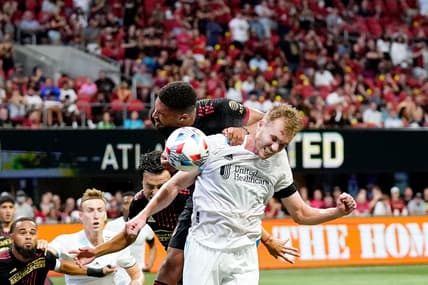 Jul 17, 2021; Atlanta, Georgia, USA; New England Revolution defender Henry Kessler (4) and Atlanta United defender George Campbell (32) battle for a header during the first half at Mercedes-Benz Stadium. Mandatory Credit: Dale Zanine-USA TODAY Sports