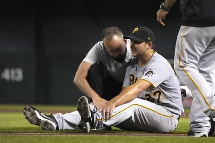 Jul 19, 2021; Phoenix, Arizona, USA; Pittsburgh Pirates starting pitcher Chase De Jong (37) gets checked by the trainer in the third inning against the Arizona Diamondbacks at Chase Field. Mandatory Credit: Rick Scuteri-USA TODAY Sports