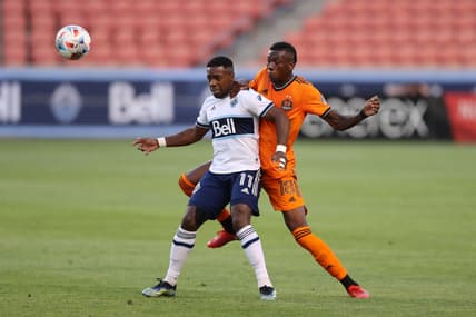 Jul 20, 2021; Sandy, Utah, USA; Vancouver Whitecaps forward Cristian Dajome (11) and Houston Dynamo defender Teenage Hadebe (18) play for a ball during the first half at Rio Tinto Stadium. Mandatory Credit: Rob Gray-USA TODAY Sports