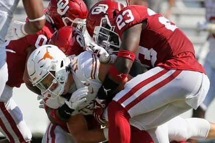 OU's DaShaun White (23) and Delarrin Turner-Yell (32) bring down Texas quarterback Sam Ehlinger (11) during the Sooners' 53-45 win in Dallas on Oct. 10, 2020.

ehlinger