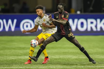 Jul 24, 2021; Atlanta, Georgia, USA; Columbus Crew defender Saad Abdul-Salaam (26) and Atlanta United forward Machop Chol (30) battle for control of the ball during the first half at Mercedes-Benz Stadium. Mandatory Credit: Dale Zanine-USA TODAY Sports