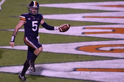 Nov 14, 2020; Charlottesville, Virginia, USA; Virginia Cavaliers quarterback Brennan Armstrong (5) celebrates after scoring a touchdown against the Louisville Cardinals in the fourth quarter at Scott Stadium. Mandatory Credit: Geoff Burke-USA TODAY Sports